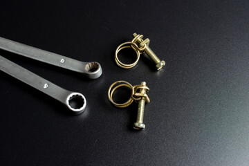 metal wire clamps and tools on black background