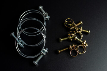 Fototapeta na wymiar metal clamps of wire on a black background