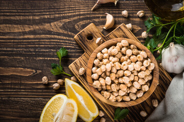 Chickpeas in white bowl at light kitchen table.