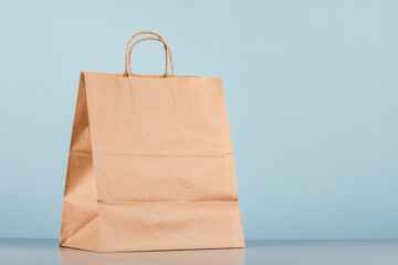 Brown paper bag with handles, empty shopping bag with area for your logo or design, food delivery...