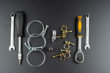 metal wire clamps and tools on black background
