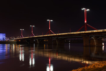 Fototapeta na wymiar Budapest at night, Rakoczi bridge on the Danube river, reflection of night lights on the water