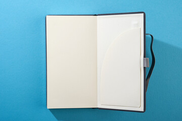 blank note pad on blue background