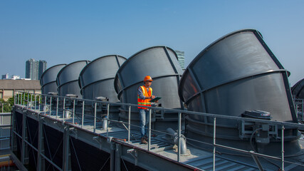 engineer under checking the industry cooling tower air conditioner is water cooling tower air...