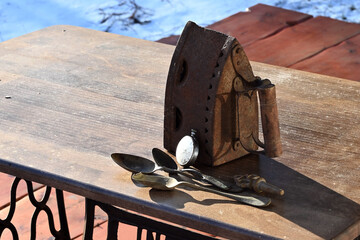 vintage antiques. The iron, the spoons, the clock in the sunlight.