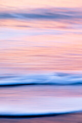 abstract landscape of sea. texture water, sky and sand in blurry motion in tropical sunset colors