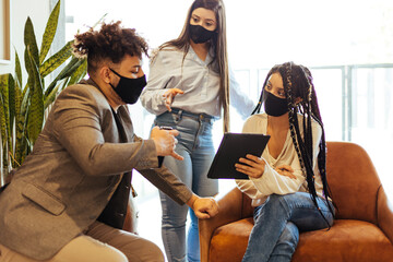 Business team wearing protective masks while talking in the office during the COVID-19 epidemic