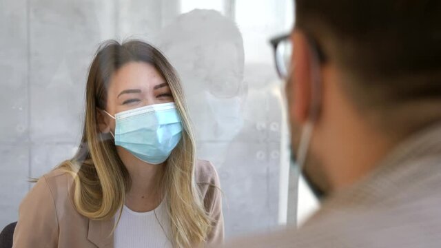 Business woman wearing a mask social distancing in office