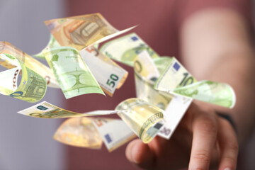 euro bills flying around  in hand