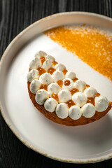 dessert with bize and orange jam on a white plate
