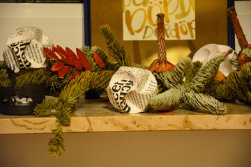 Christmas decorations with fir branches and paper balls on windowsill