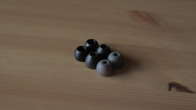 Set of ear tips on wooden surface