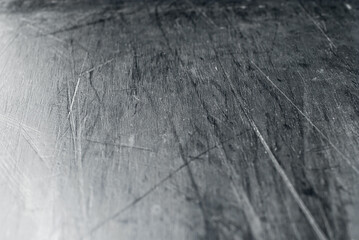 White scratches and dust on black plastic. Scratches on a snowboard close up. Paraffin application...
