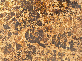 Texture of yellow and orange marble. Stone tile with natural pattern. Marble pavement closeup.