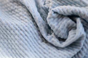 Cozy knitted thick wool blanket. Full wavy texture background. Blue color.