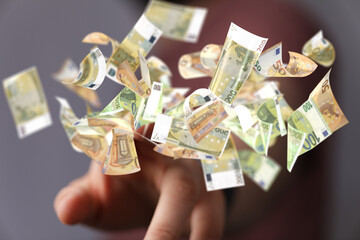 euro bills flying around  in hand