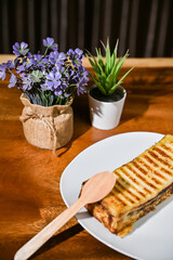 Bread toast close up view with decorative plant on wooden table