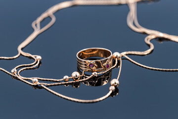 Wide gold ring and chain with large gold beads