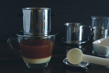 Sweetened condensed milk with hot coffee dripping in Vietnam style.