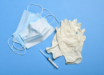 medical protective face mask for respiratory protection against germs, covid or coronavirus, and syringe with latex gloves