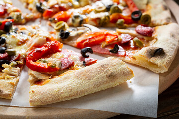 Close up of pizza on wooden cutting board