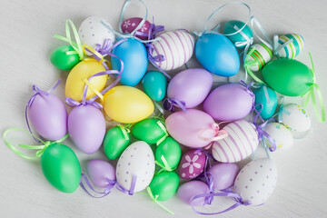 Pastel color plastic Easter eggs decoration on a light background
