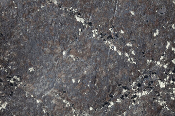 Background and texture of stone from an ancient rock with different patterns for design and geology.