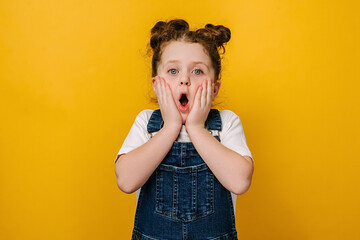 Surprised little preschool girl look at camera feel stunned amazed by unexpected good news, happy...