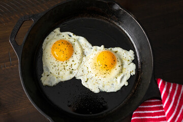 Organic farm fresh eggs cooked in a skillet. 