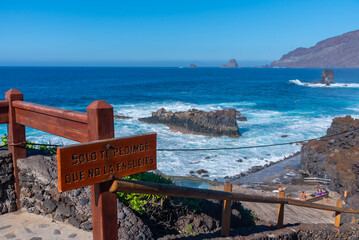 Sign saying in Spanish We only ask you not to kill yourself at La Maceta rock pool at EL Hierro...