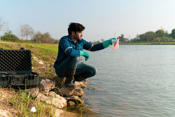 A technician use the Professional Water Testing equipment to measure the water quality at the public canal ,Portable multi parameter water quality measurement ,water quality monitoring concept