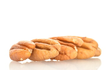 Several ripe peeled pecans, close-up, isolated on white.