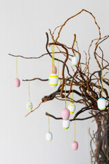 Colored easter eggs on tree branches in vase