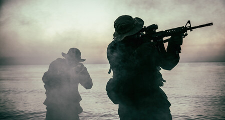Commando soldiers walking in water, army special operations forces fighters sneaking in darkness,...