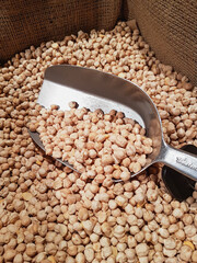 Сhickpeas with a ladle in the store