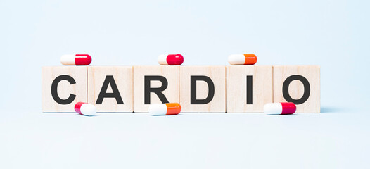 CARDIO word made on wooden cube blocks and flower in a pot on background. Health and medicine concept. Healthcare concept.