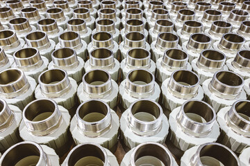 many metal pipe couplings in a pipe factory