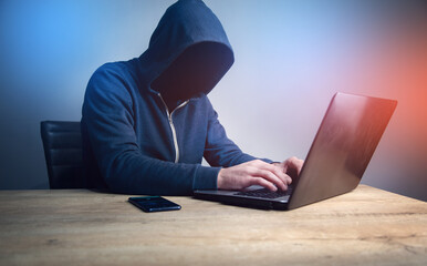 Programmer or computer hacker typing code