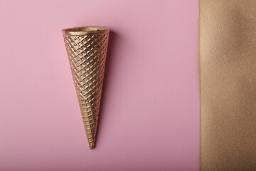 golden cone on pink background