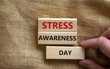Stress awareness day symbol. Wooden blocks with words 'Stress awareness day'. Beautiful canvas...