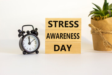 Stress awareness day symbol. Wooden blocks with words 'Stress awareness day'. Beautiful white...