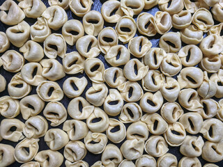 A close up top view shot of raw Tortellini with white mushrooms Texture Food photography