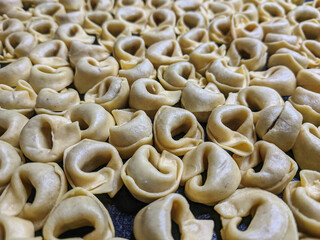 A close up top view shot of raw Tortellini with white mushrooms Texture Food photography