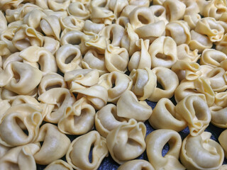 A close up top view shot of raw Tortellini with white mushrooms Texture Food photography