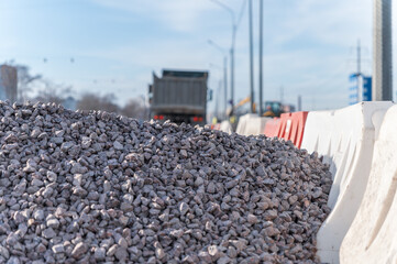 A pile of rubble on the road and the  blurred truck on background