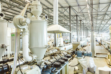 Workshop with extruders for producing plastic pipes. High speed extrusion line of water suppply and...