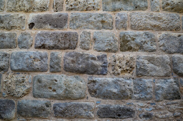 Fototapeta premium Texture of a stone wall. Old castle stone wall texture background. Stone wall as a background or texture. Part of a stone wall, for background or texture