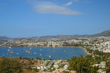 Fototapeta na wymiar Beautiful marine landscape. Panorama View from the hill to the Gumbet bay in sunny day. Bodrum, Turkey