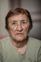Close-up portrait of an elderly wrinkled woman.