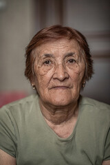 Close-up portrait of an elderly wrinkled woman.